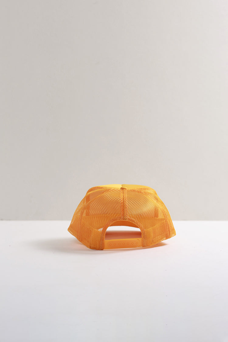 A bright yellow-orange mesh baseball cap viewed from the back, resting on a white surface against a light gray background.